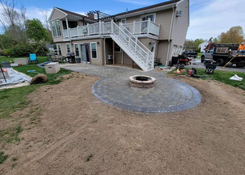 Luxury Patio with Fire Pit by J&M Stone & Garden