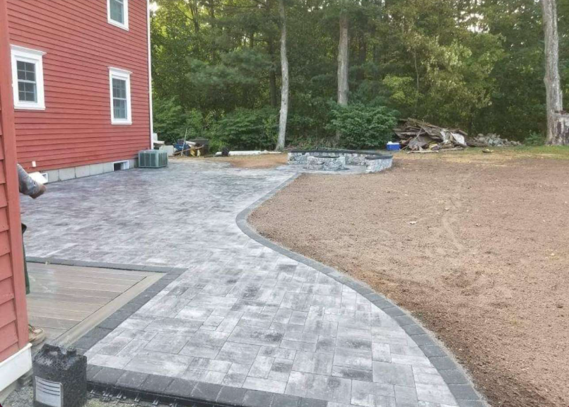 Curved Paver Walkway Leading to Stone Fire Pit Area
